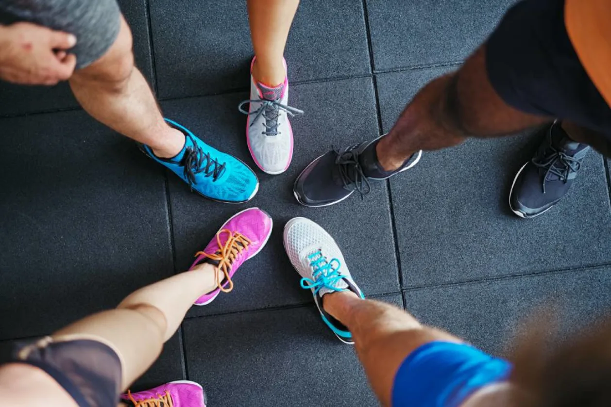 Group of runners showing off running shoes